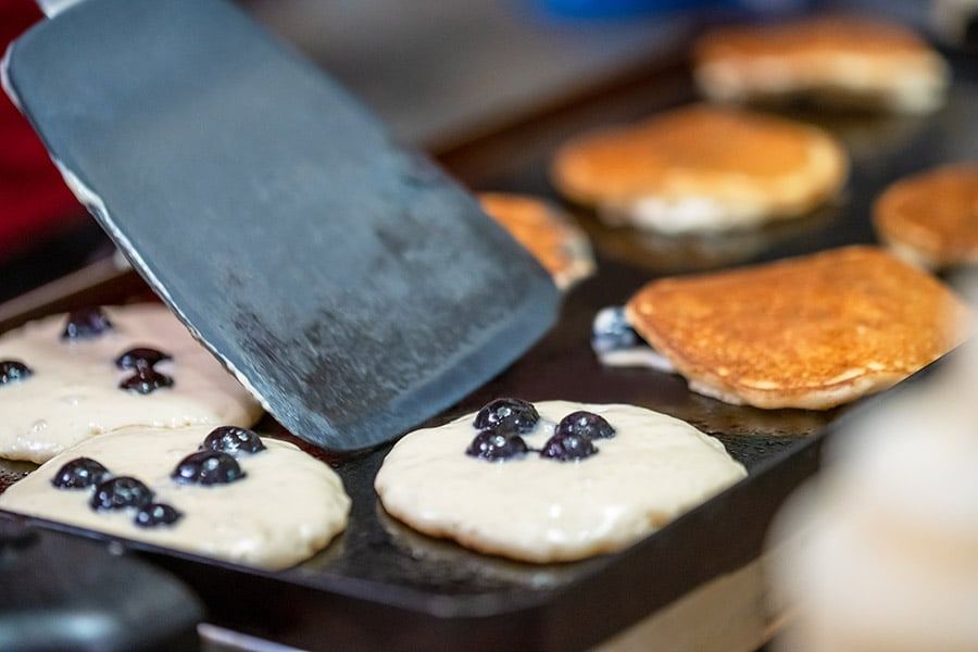 Blueberry pancakes cooking on the griddle at Bent Creek Lodge
