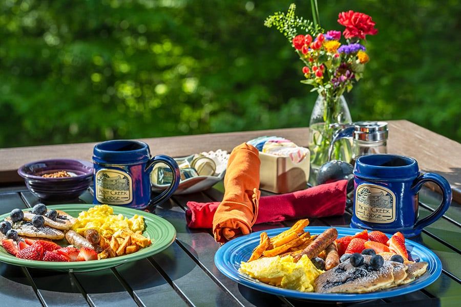 A full breakfast for two served on the covered porch at Bent Creek Lodge