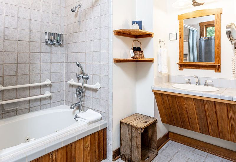 The accessible bathroom with grab bars and whirlpool tub in the Barn Room