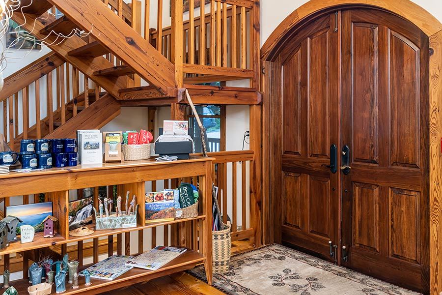 The lodge entry with arched wooden doors and the gift shop corner