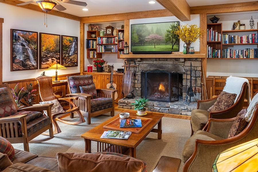 The great room at Bent Creek Lodge with a stone fireplace and timber beams
