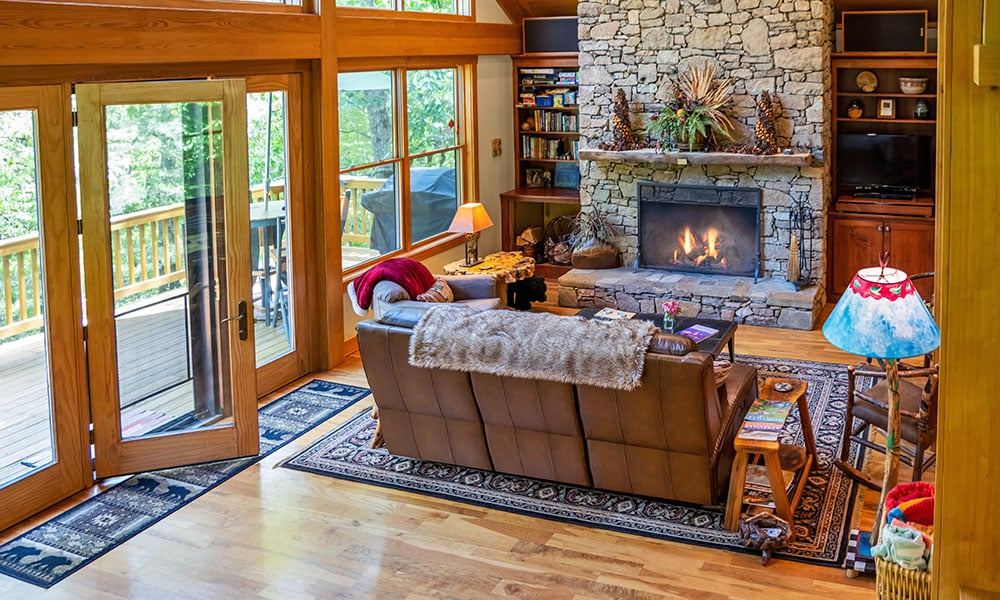 The Luhn House great room with a massive stone fireplace