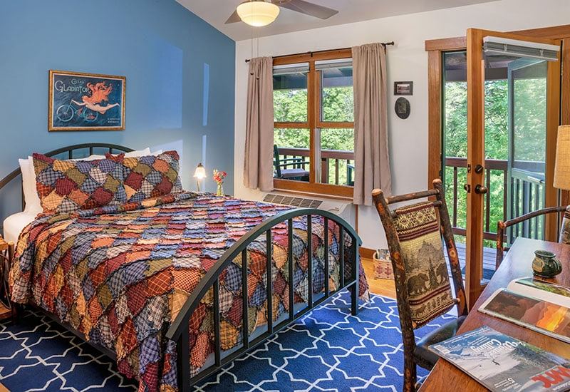 The Bike Room at Bent Creek Lodge with a queen iron bed and vintage bike art